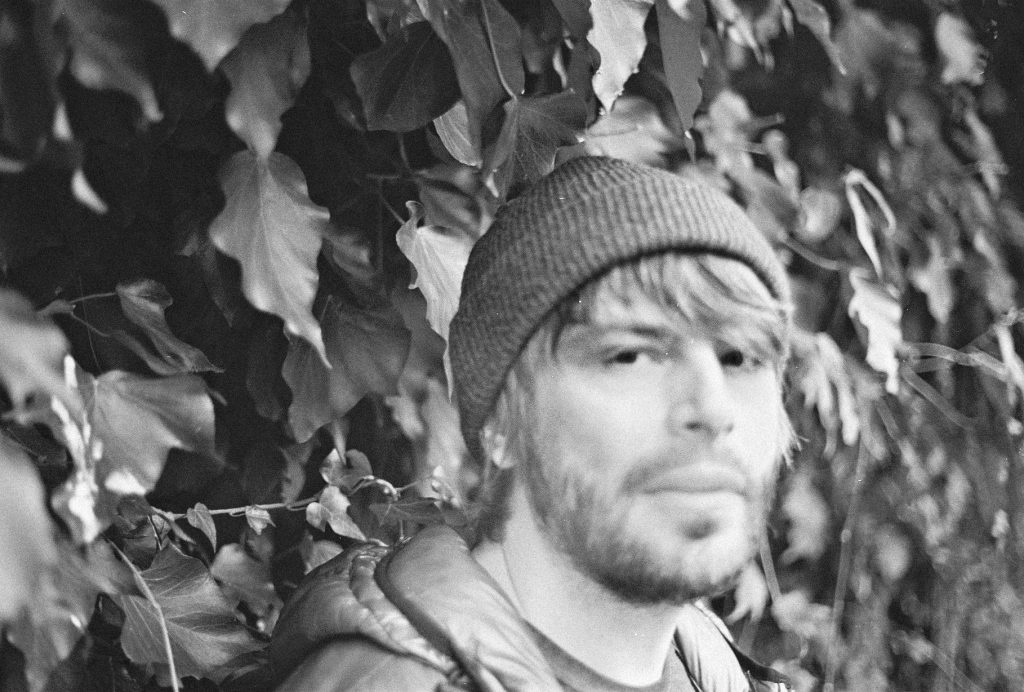 Benson Taylor, black and white portrait among ivy leaves